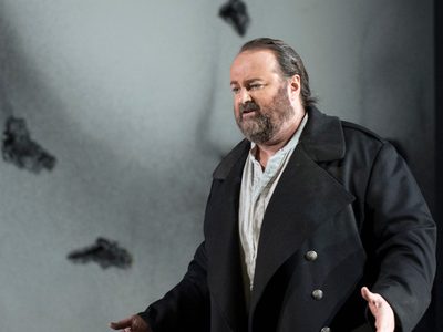 La Forza Del Destino Gwyn Hughes Jones Don Alvaro Photo Credit Richard Hubert Smith 5933 Richard Hubert-Smith 2018 Man looking anguished with a large eye on the backdrop.