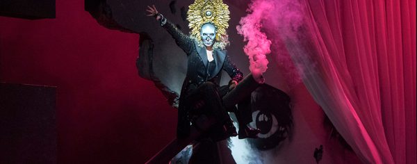 La Forza Del Destino Justina Gringyté Preziosilla Photo Credit Richard Hubert Smith 3724 Richard Hubert Smith Preziosilla sits, surrounded by pink smoke, right arm raised in the air.