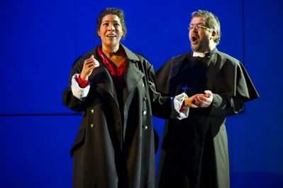 La Forza Del Destino Mary Elizabeth Williams Donna Leonora And Miklós Sebestyén Photo Credit Richard Hubert Smith 3352 Richard Hubert-Smith 2018 Vicar holds woman's hand while she looks forward with a happy expression on her face.