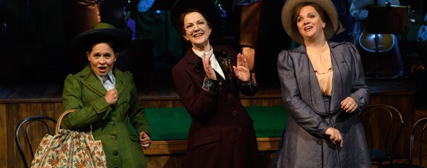 WNO Rhondda Rips It Up! Catherine Wood Lottie Rosie Hay Sybil And Madeleine Shaw Lady Rhondda Photo Credit © Jane Hobson 2705 Jane Hobson 2018 Lottie, Sybil and Lady Rhondda appear jolly, singing to the audience, with the orchestra in the background.