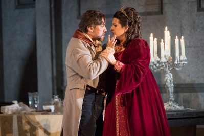 WNO Tosca Hector Sandoval Cavaradossi And Claire Rutter Tosca Photo Credit Richard Hubert Smith 5234 Richard Hubert-Smith 2018 Man and woman stand facing each other closely, she holds his wrist away from her.