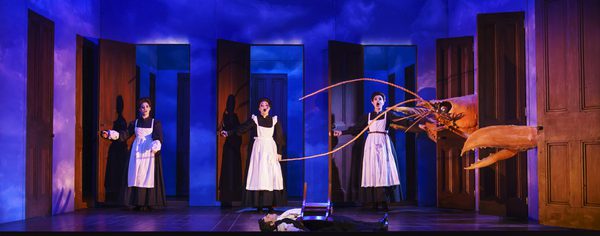 WNO The Magic Flute Jennifer Davis First Lady Kezia Bienek Second Lady Emma Carrington Third Lady Photo credit Bill Cooper 0022 Bill Cooper 2019 Three maids stand in three doorways, giant lobster comes through side doorways