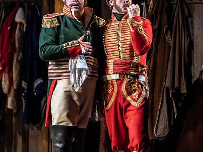 WNO War and Peace David Stout Dolokhov and Adrian Dwyer Anatole Photo credit Clive Barda 0091 Clive Barda Dolokhov and Anatole stand upright, close together, they appear surprised.