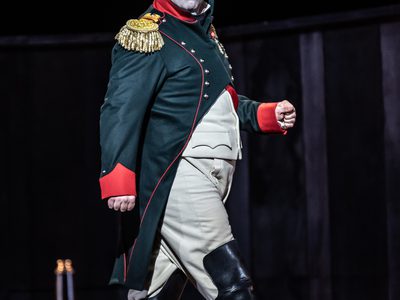 WNO War and Peace David Stout Napoleon Photo credit Clive Barda 0937 Clive Barda Napoleon struts along the stage with a fierce expression on his face.