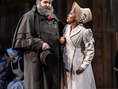 WNO War and Peace James Platt Count Rostov and Lauren Michelle Natasha Photo credit Clive Barda 0118 Clive Barda Natasha looks up at Count Rostov with a concerned expression.