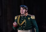 WNO War and Peace Jonathan Mc Govern Andrei Photo credit Clive Barda 0869 Clive Barda Andrei looks out, right arm slightly raised.