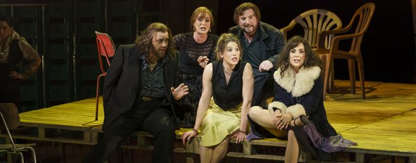 WNO Carmen Benjamin Bevan Harriet Eyley Virginie Verrez Joe Roche Angela Simkin Photo Credit Bill Cooper 1040 Men and women sit in a huddle in fine coats, they appear to be addressing someone