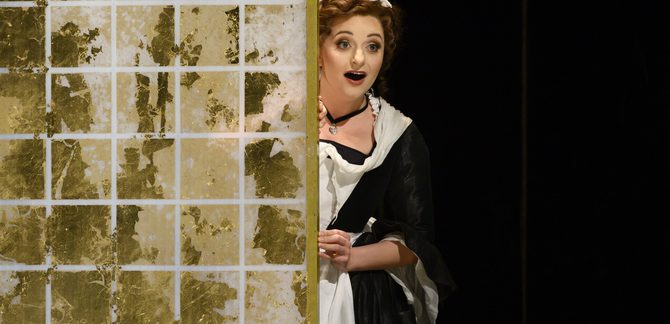 WNO The Marriage of Figaro Soraya Mafi Susanna Photo credit Richard Hubert Smith1747 Richard Hubert-Smith 2020 Maid peering around the side of a wall looking slightly shocked.