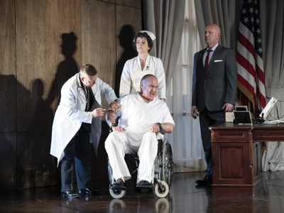WNO Rigoletto 2019 Eddie Wade Monterone Photocredit Richard Hubert Smith 3973 Richard Hubert-Smith 2019 Man in white chair and white scrubs looking distressed, with nurse and doctor