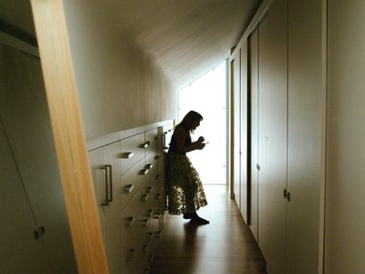 La Voix Humaine Claire Booth 04 WEB Claire Booth Woman standing in slumped posture between cupboards and wardrobes