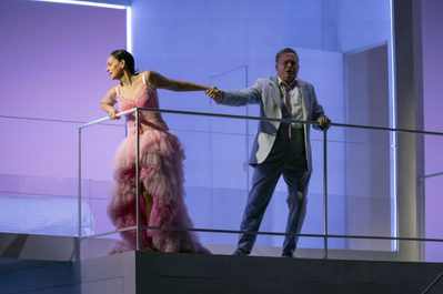 WNO Madam Butterfly Alexia Voulgaridou Cio Cio San Peter Auty Pinkerton photo credit Richard Hubert Smith 8138 Cio Cio San leaning over barrier on stage while Pinkerton pulls her back holding hand