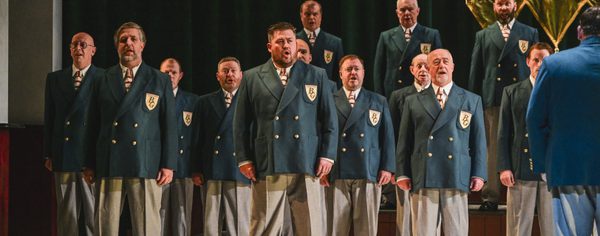 WNO Blaze of Glory Cast of Blaze of Glory photo credit Kirsten Mcternan 546 The Male Voice Choir performs together at the Eisteddfod