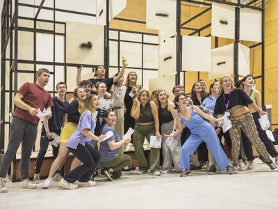 WNYO Cherry Town Moscow Cast photo credit Craig Fuller 11 youth opera cast pose before a mock up of the set