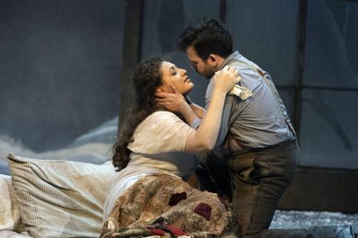 WNO La bohème Anush Hovhannisyan Mimi Luis Gomes Rodolfo photo credit Richard Hubert Smith 9463 a man and woman, lying in bed embracing romantically