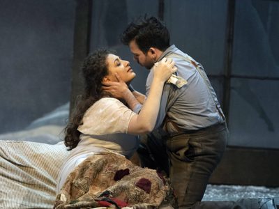 WNO La bohème Anush Hovhannisyan Mimi Luis Gomes Rodolfo photo credit Richard Hubert Smith 9463 a man and woman, lying in bed embracing romantically