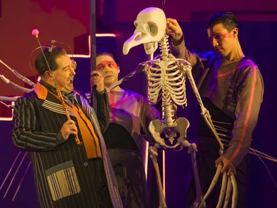 WNO The Magic Flute Alun Rhys Jenkins Monostatos Kim Scopes Puppet Captain Tom Stacy Puppeteer photo credit Craig Fuller 3505 A large puppet of a bird skeleton interacts with a strange man in a suit
