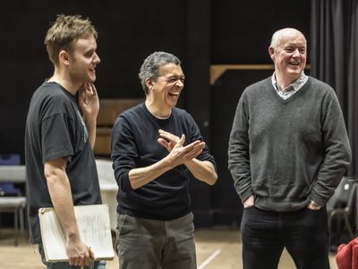 WNO Death in Venice Alexander Chance Voice of Apollo Roderick Williams Traveller Mark Le Brocq Gustav von Aschenbach photo credit Craig Fuller 9347 A Death in Venice rehearsal shot showing three men laughing