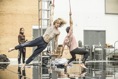 WNO Death in Venice Selma Hellman Daughter 1 Antony Cesar Tadzio and Riccardo Saggese Governess photo credit Craig Fuller1350 A rehearsal shot of two men hanging from aerial silk from their arms