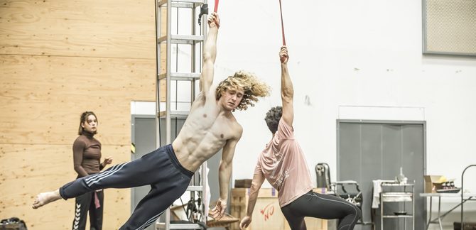 WNO Death in Venice Selma Hellman Daughter 1 Antony Cesar Tadzio and Riccardo Saggese Governess photo credit Craig Fuller1350 A rehearsal shot of two men hanging from aerial silk from their arms