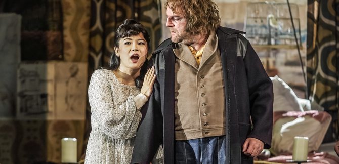 WNO Gianni Schicchi Haegee Lee Lauretta Roland Wood Gianni Photo Credit Craig Fuller IMG 6537 A production shot from Gianni Schicchi showing Lauretta in a white singing whilst holding her father, Gianni Schicchi's arm
